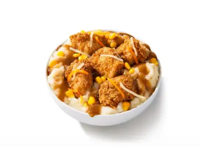 KFC Loaded Smash'd Potato Bowl with Nuggets: cheesy smashed potatoes, Secret Recipe fries, cheese sauce, bacon crumbles, three-cheese blend, crispy chicken nugg