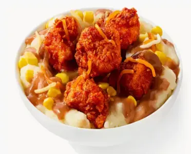 KFC Nashville Hot Mashed Potato Bowl: mashed potatoes, gravy, corn, crispy chicken nuggets, three-cheese blend, Nashville Hot sauce finish